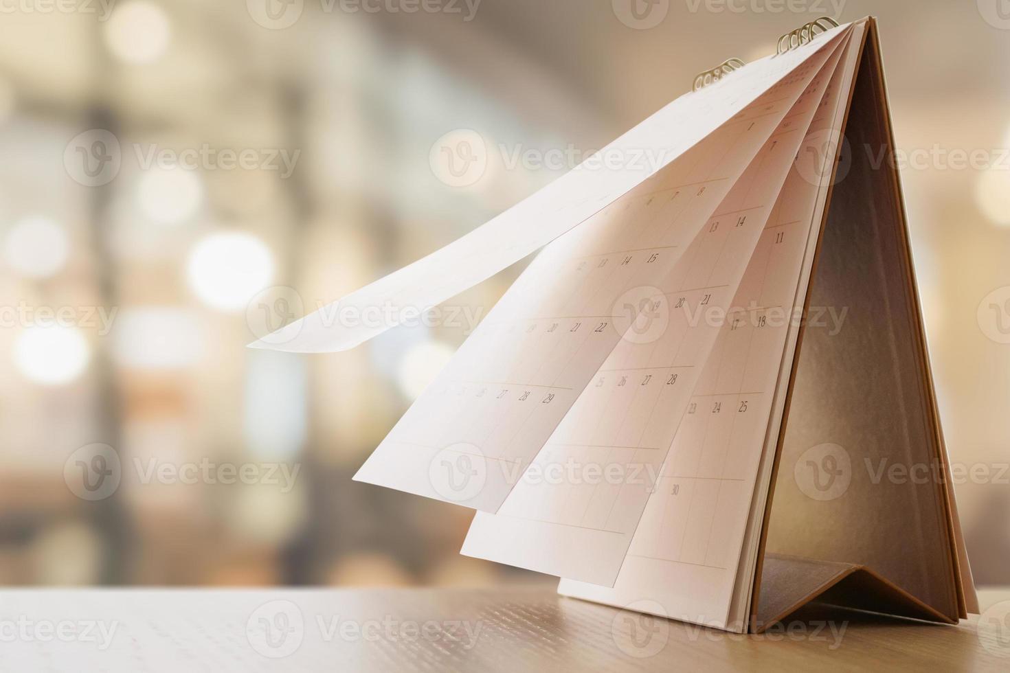 desk calendar on table with blurred bokeh background appointment and business meeting concept photo