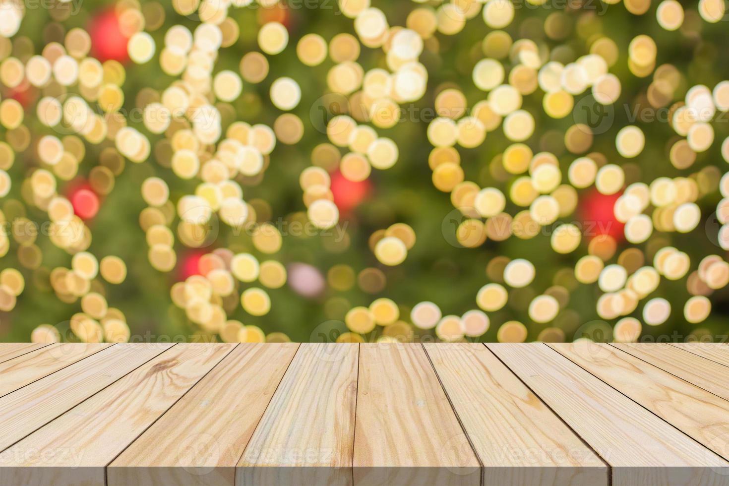 Empty wood table top with blur Christmas tree with bokeh light background photo