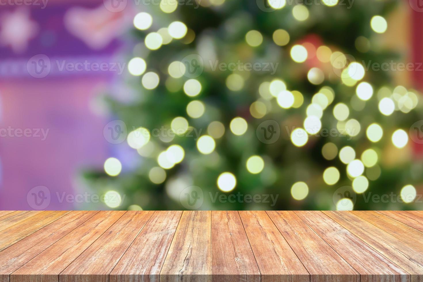 Empty wood table top with blur Christmas tree with bokeh light background photo