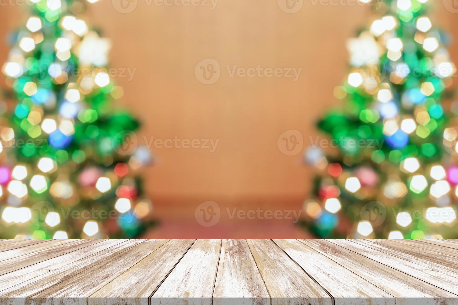 Empty wood table top with blur Christmas tree with bokeh light background photo