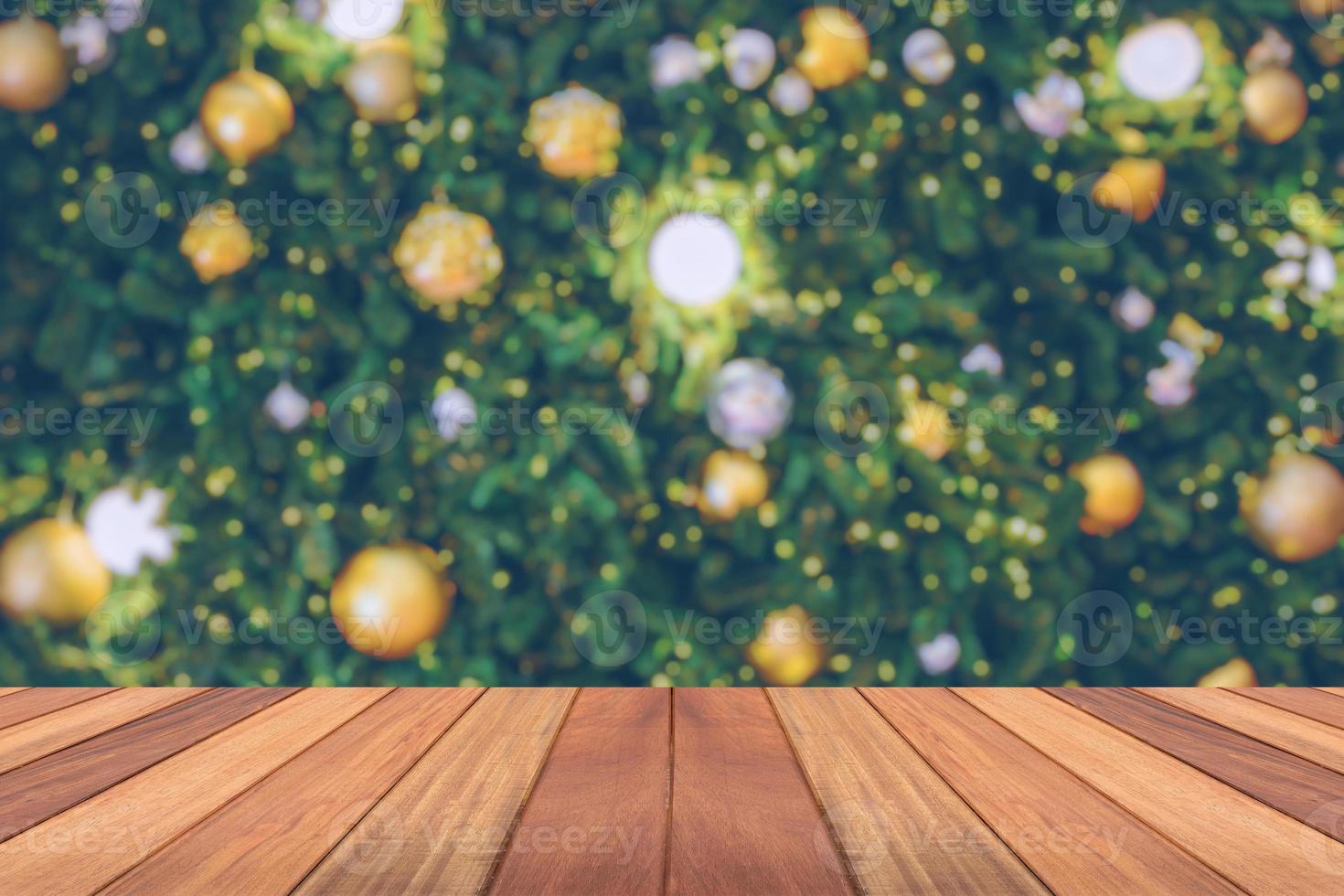 Empty wood table top with blur Christmas tree with bokeh light background photo