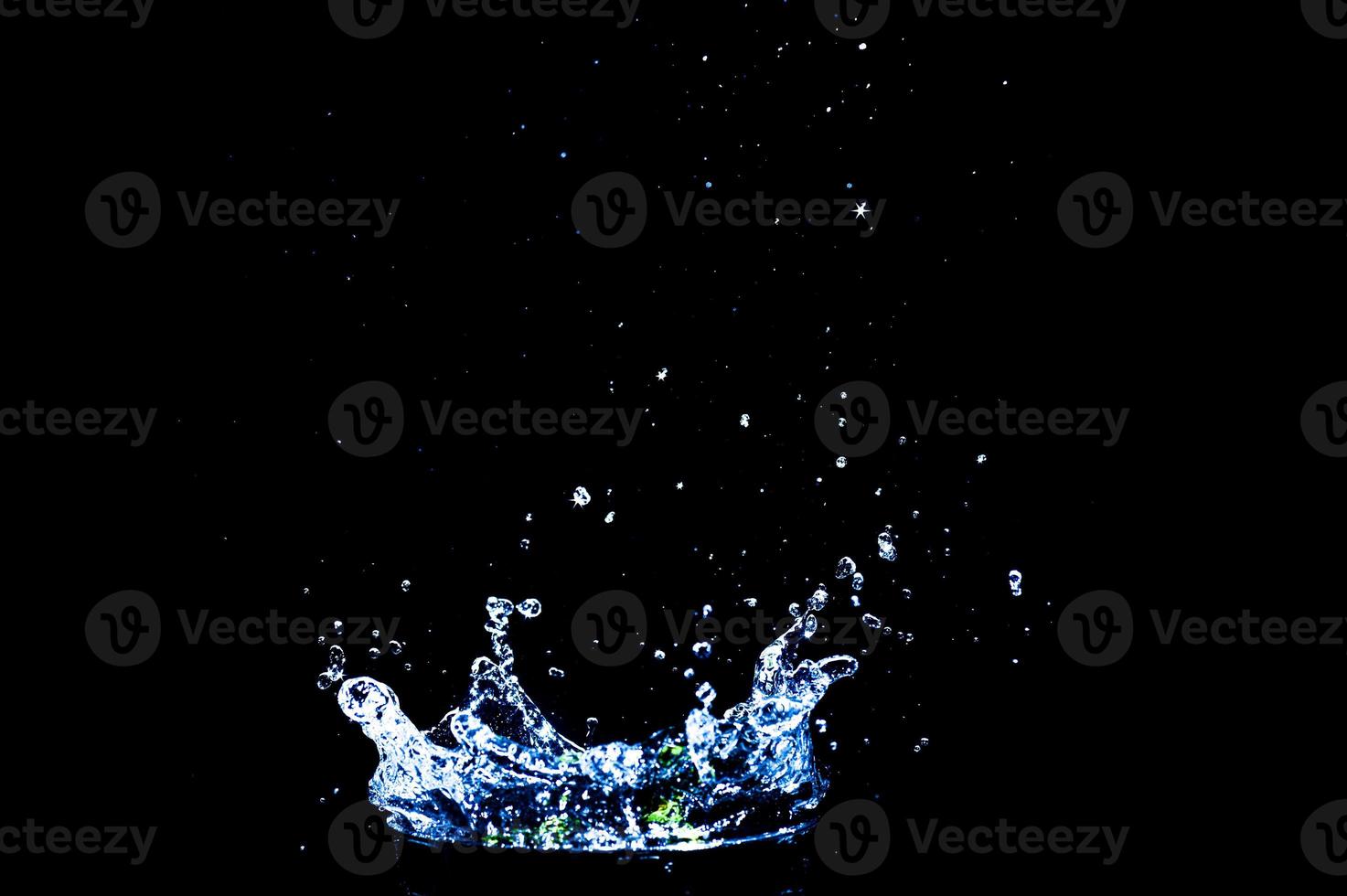 Scattered water splashes on a black background. water splash isolated on the black background photo