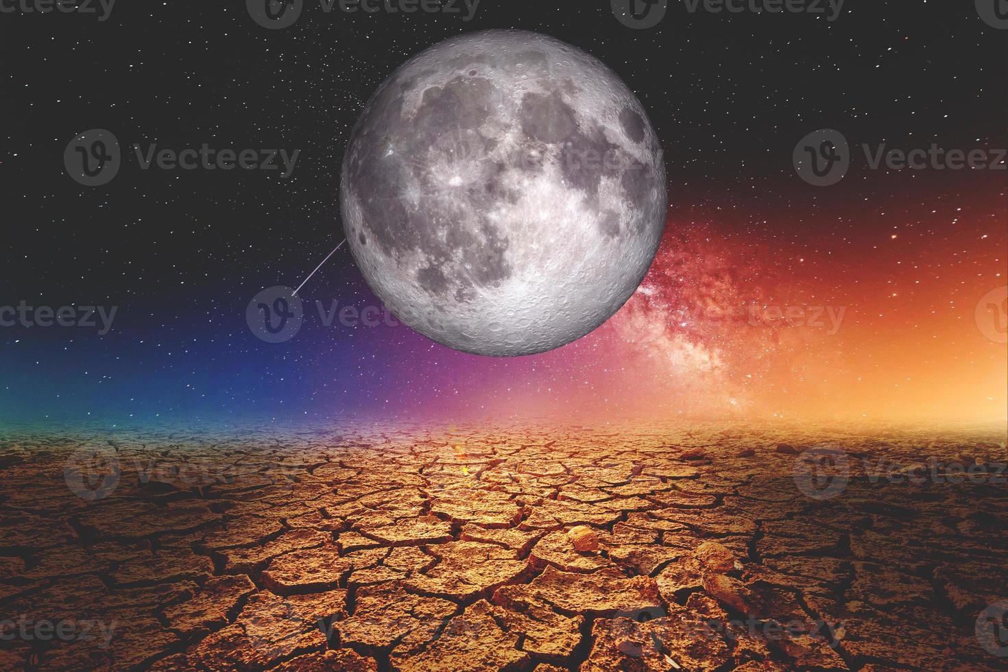 A drought-stricken area due to global warming, with the moon and stars at night. photo