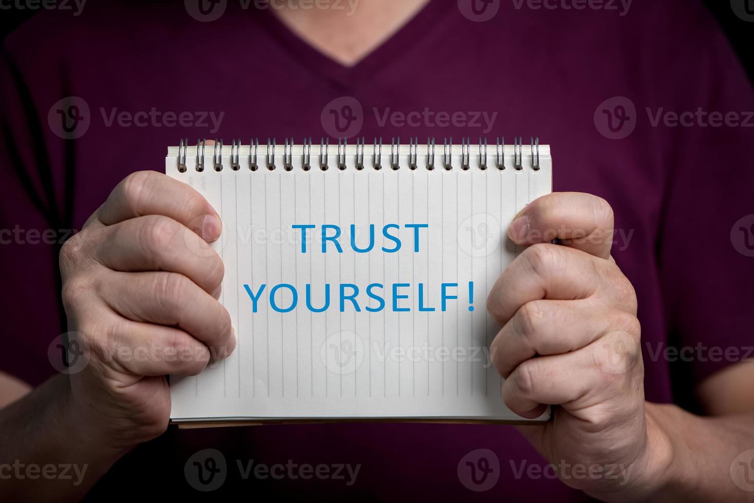 Man hands showing notebook with Trust Yourself word, positive thinking concept. photo