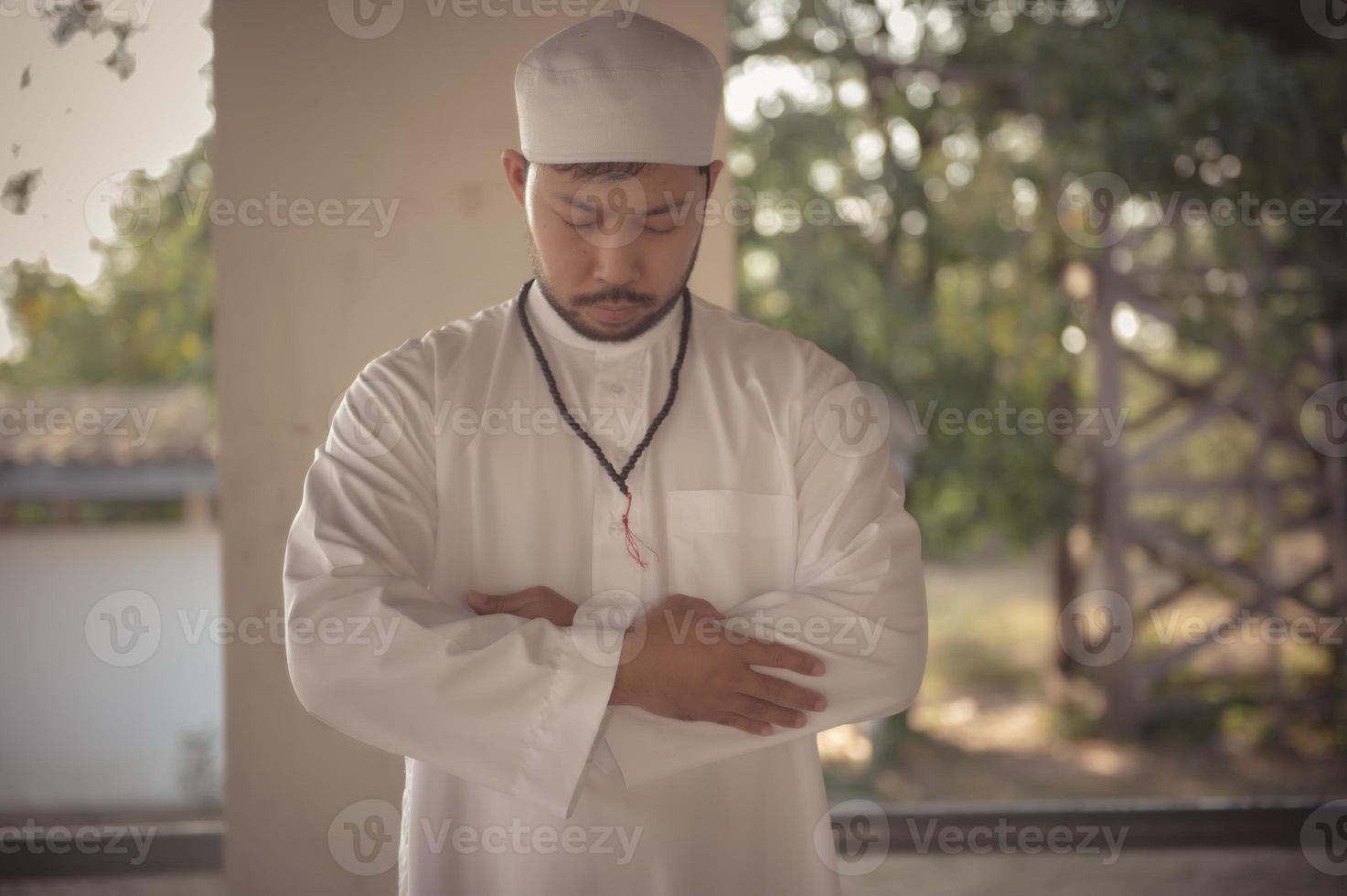 Young asian muslim man praying on sunset,Ramadan festival concept photo