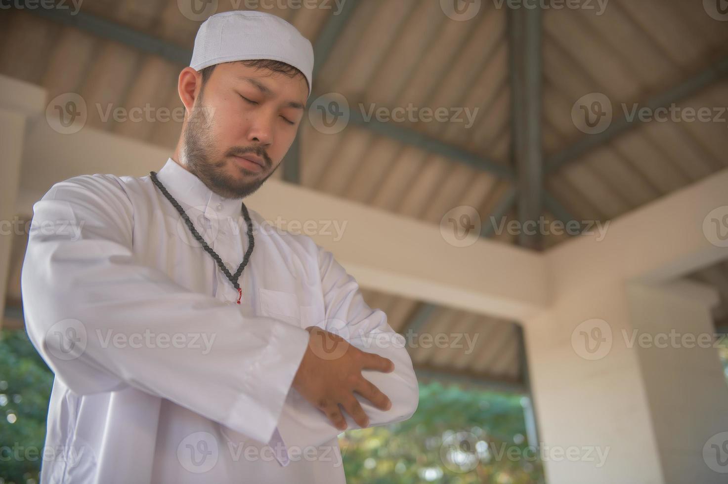 Young asian muslim man praying on sunset,Ramadan festival concept photo