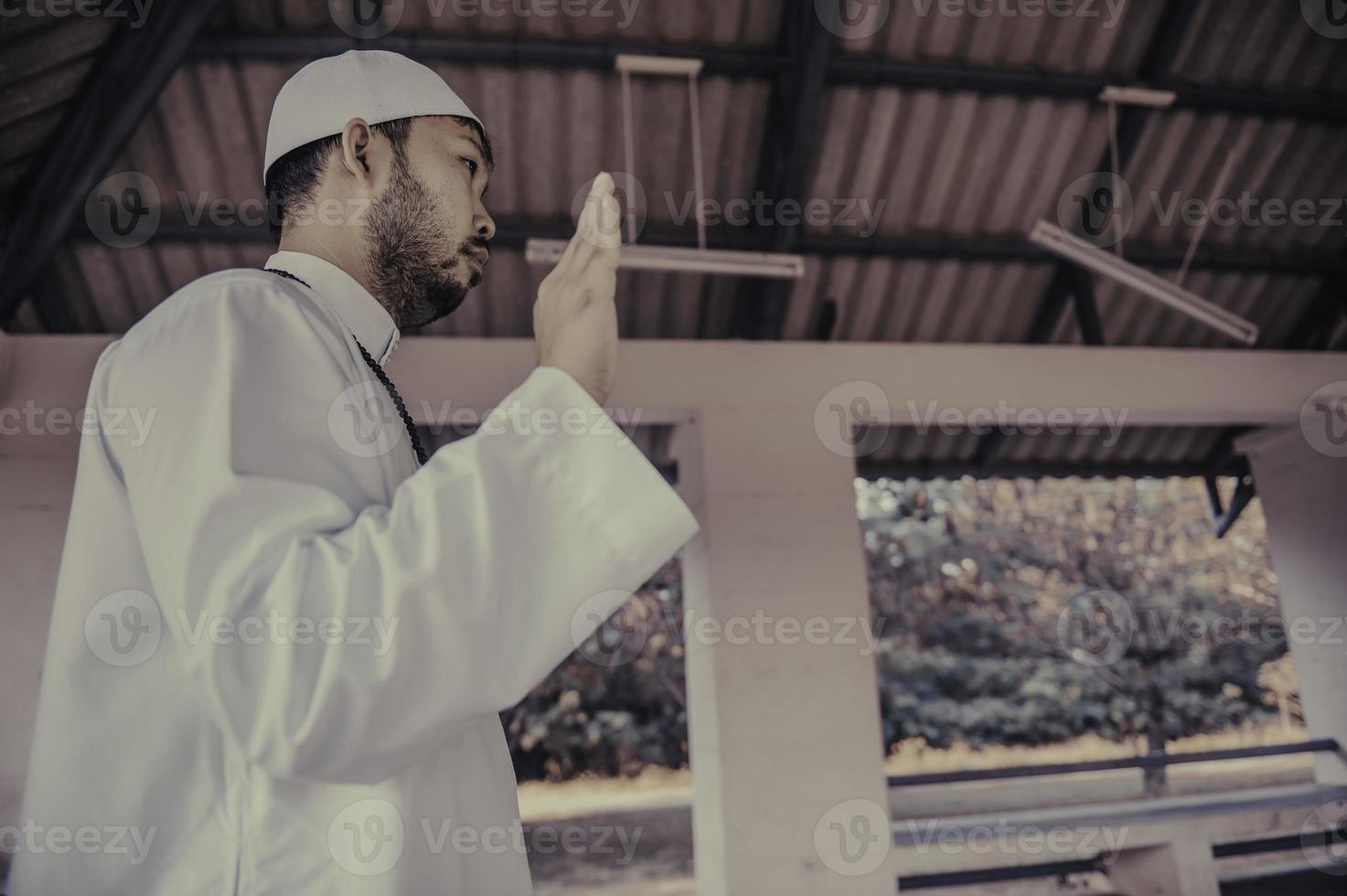 Young asian muslim man praying on sunset,Ramadan festival concept photo