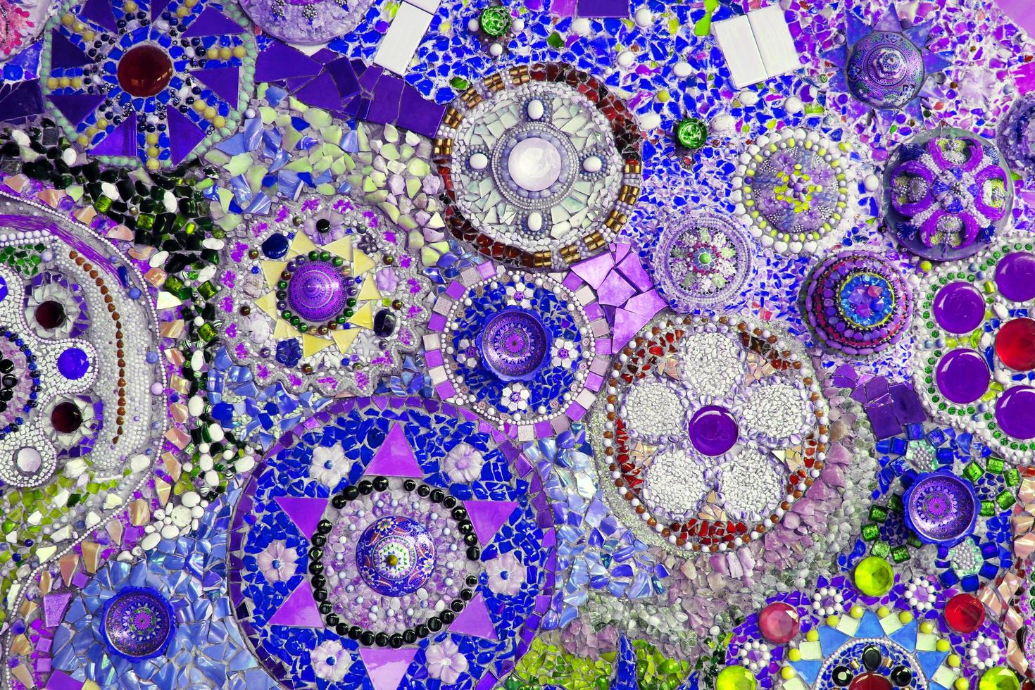 Thailand-June 22, 2021 Colorful of blue, purple or violet wall decorated with multicolor stone, gravel and gem for background. Abstract of art design with broken tile for wallpaper. photo