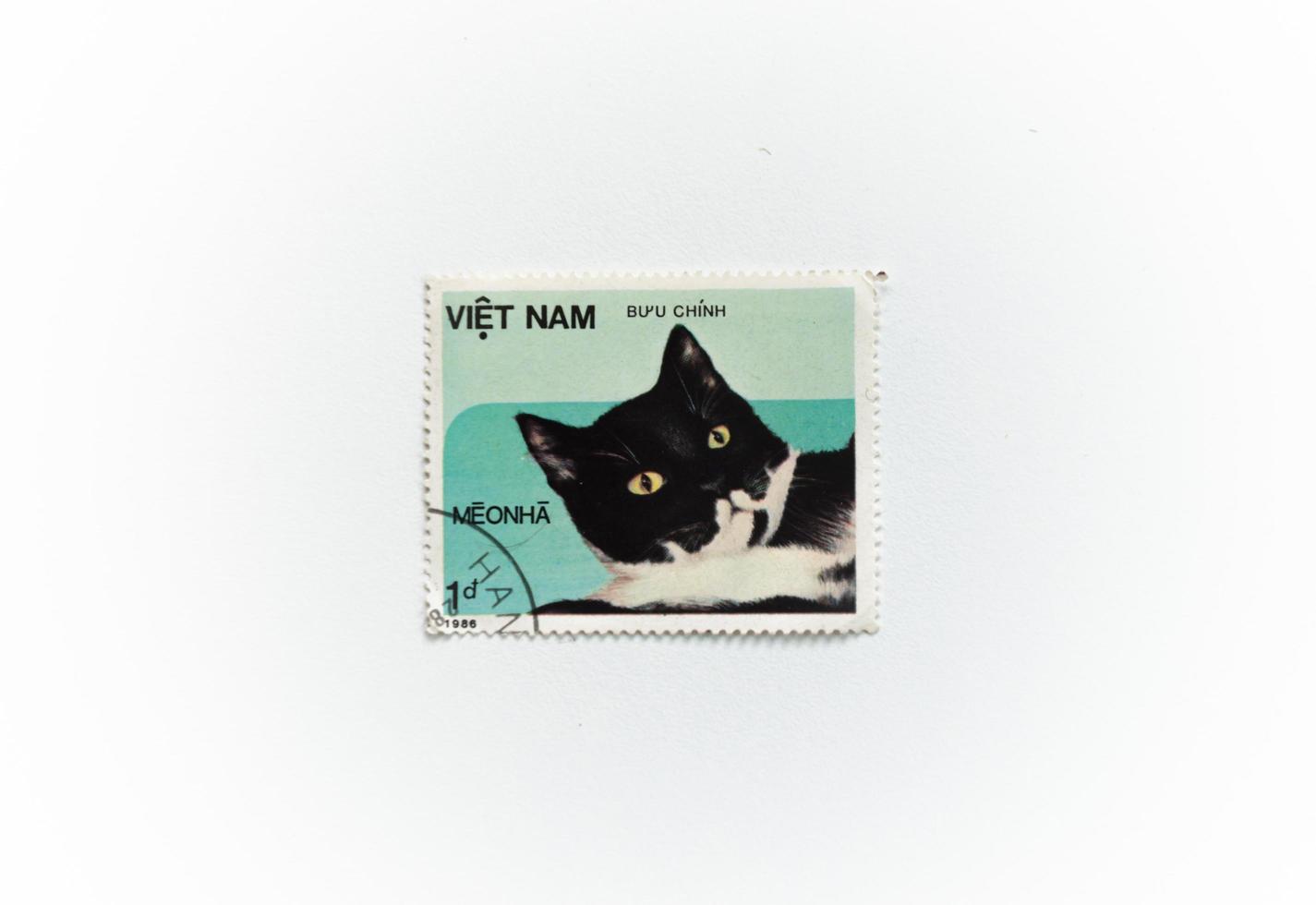 A series of postage stamps of Vietnam 1986, fauna, animals. The stamp depicts a domestic black and white shorthair cat, series Domestic cats.. photo