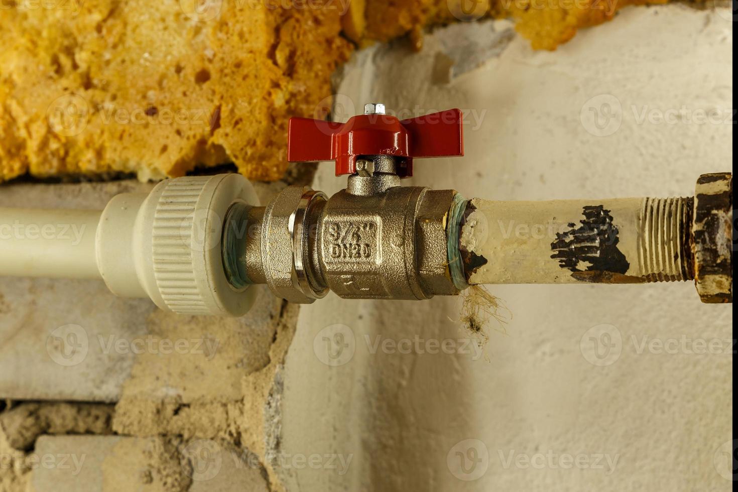 water tap on heating pipe between iron pipe and plastic pipe. Heating apartment in winter. photo