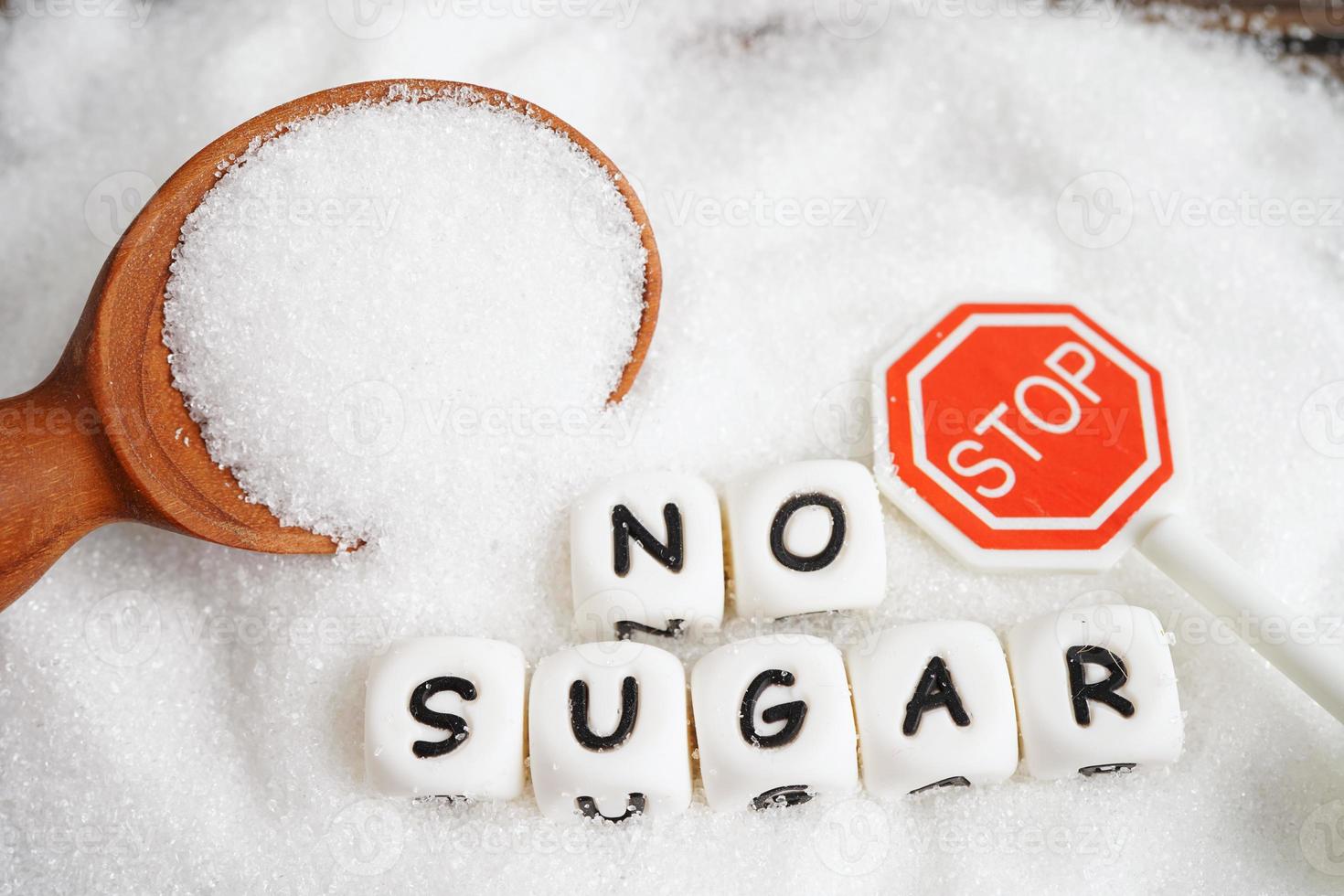 STOP, sweet granulated sugar with text, diabetes prevention, diet and weight loss for good health. photo