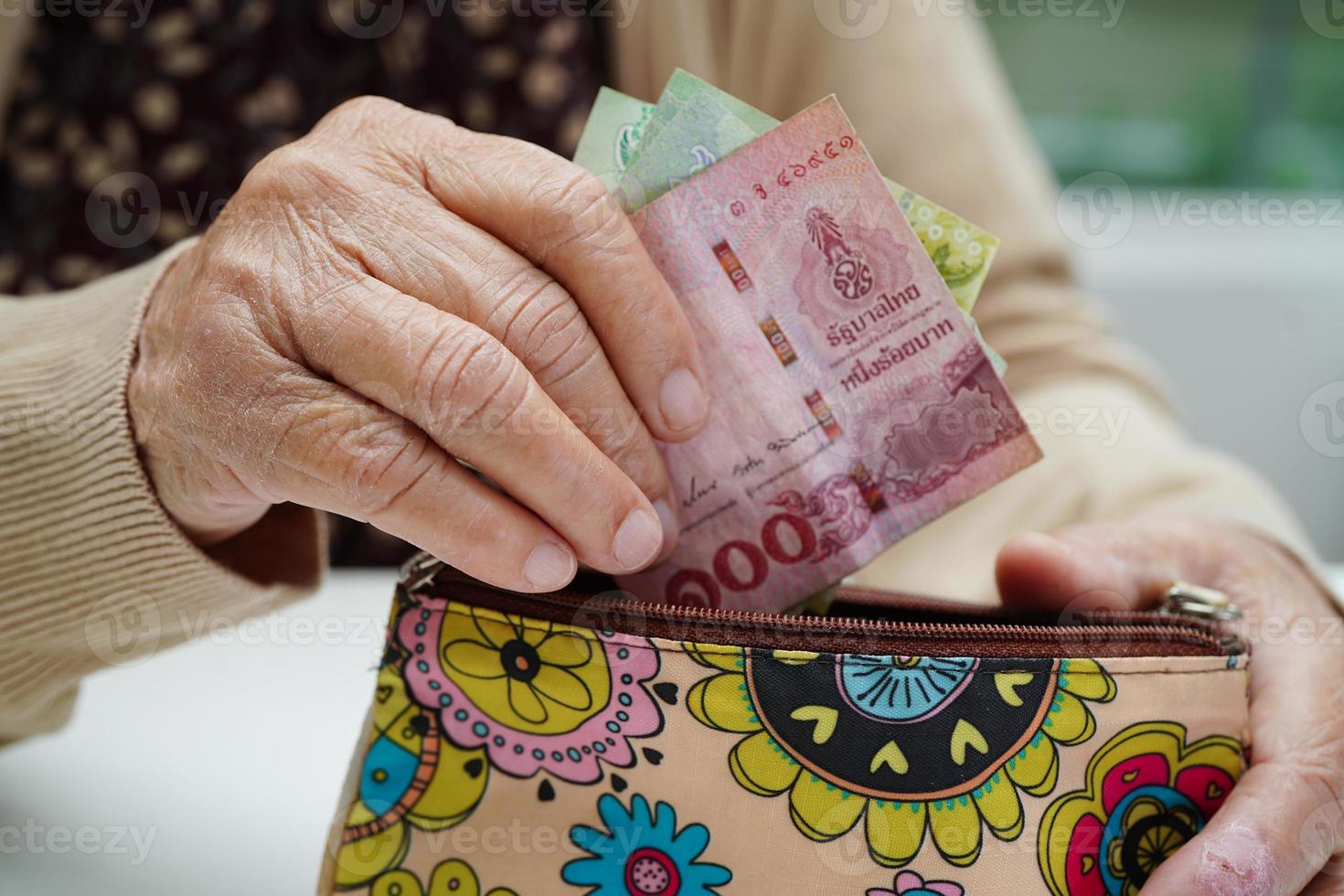 Retired elderly woman counting coins money and worry about monthly expenses and treatment fee payment. photo
