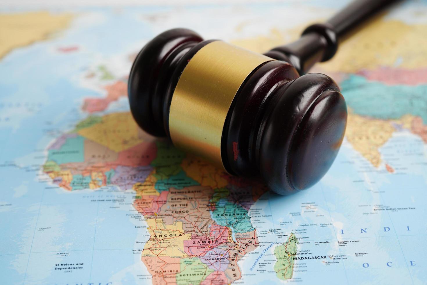 Bangkok, Thailand - May 15, 2022 Judges gavel on world map. photo