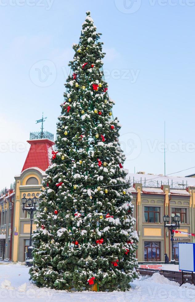 Close up decorated christmas tree balls bauble and New Year's garlands on outside in town square - xmas and winter holidays in cityscape photo