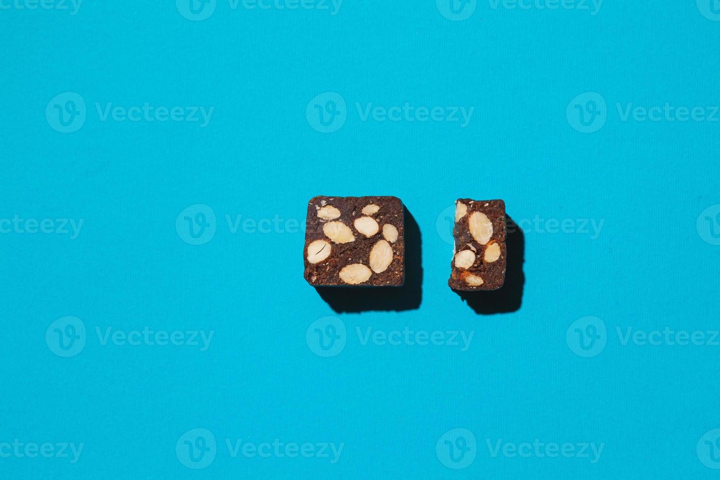 Protein date fruit candy bars fitness with nuts top view on blue background with copy space and place for text photo