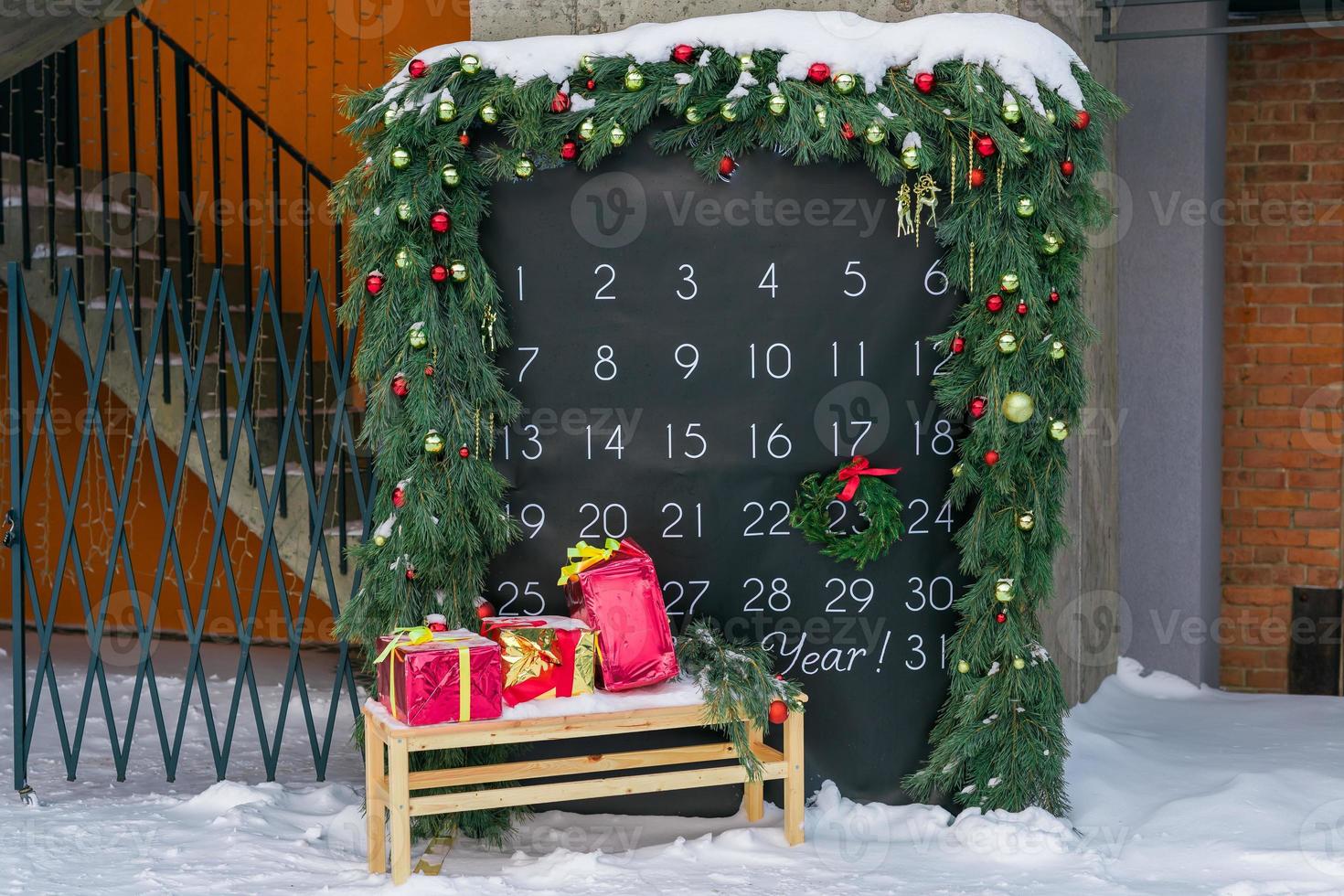 Simple desk advent calendar for December 2022 in city park with Christmas decorations photo