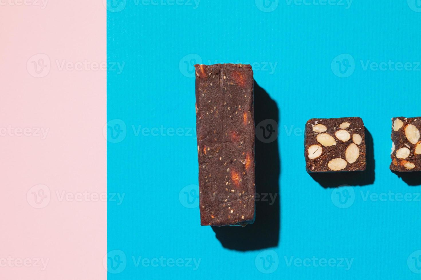 Protein date fruit candy bars fitness with nuts top view on blue background with copy space and place for text photo