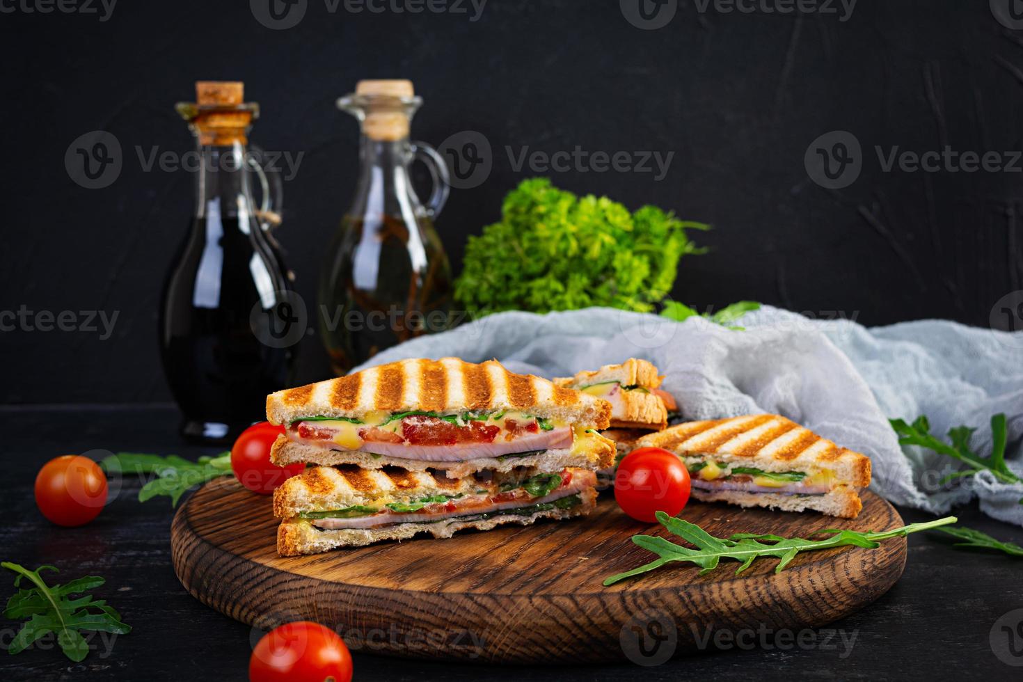 Sandwich with ham, cheese, mustard leaves, tomatoes and onion. Tasty club sandwiches photo