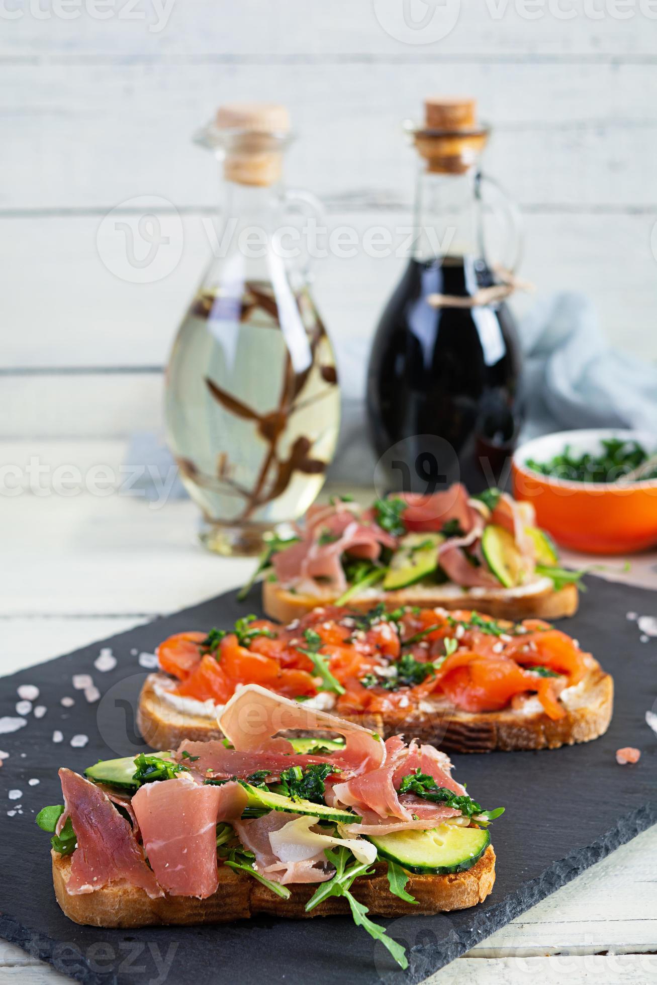Grilled bruschetta with salmon fillet and jamon. Delicious Italian ...