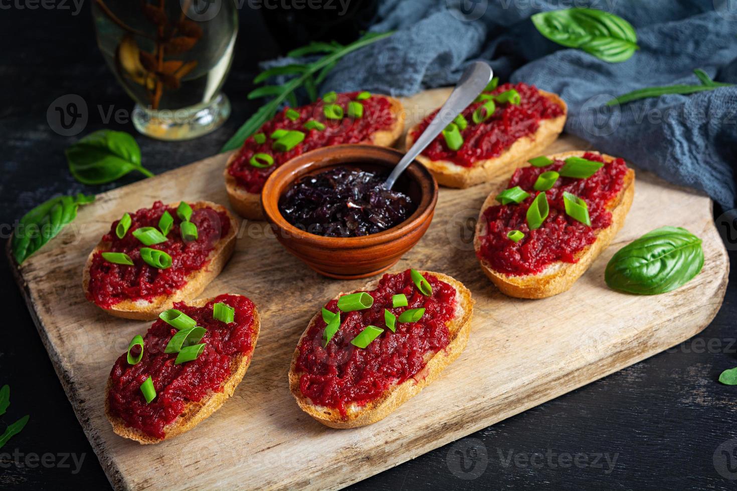 Bruschetta with grated beetroot, herbs and caramelized onion photo