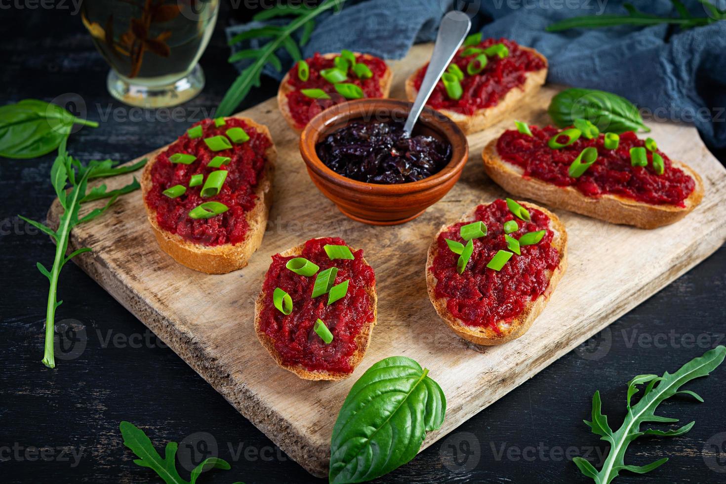 Bruschetta with grated beetroot, herbs and caramelized onion photo