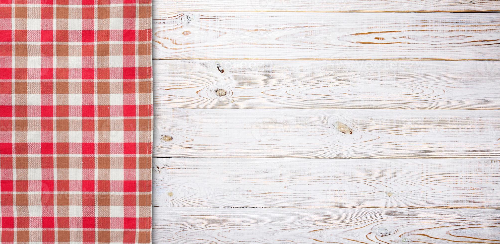 Towel or tablecloth, napkin, rough fabric texture with creased folds on wooden desk top view. photo
