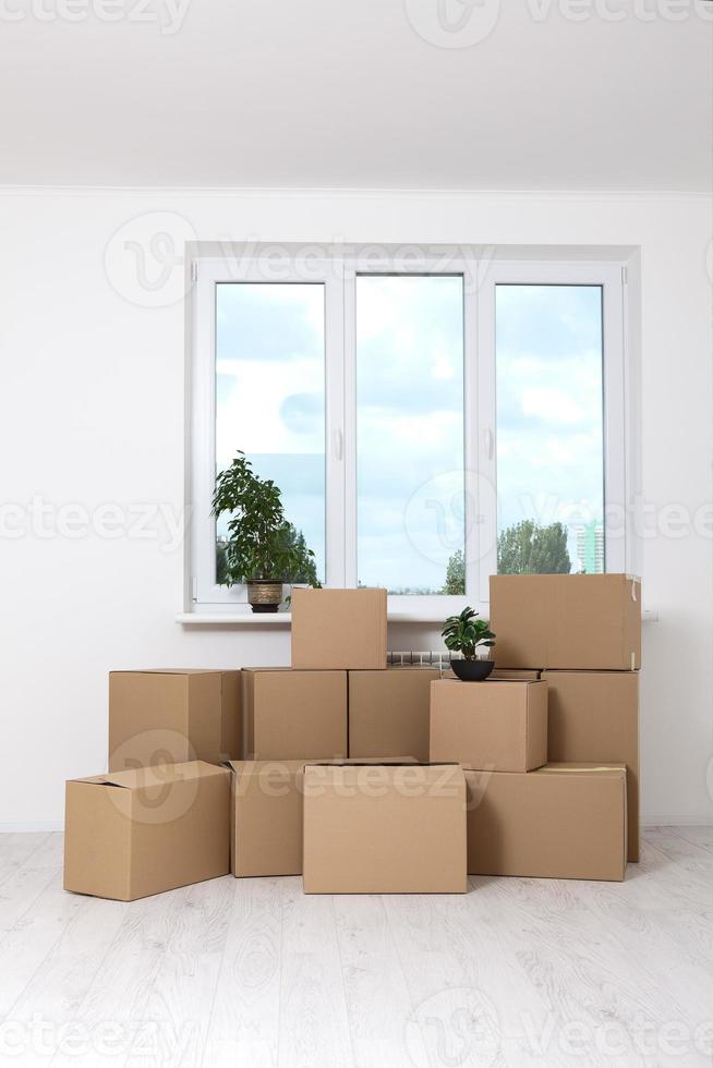 Moving into a new apartment. Move lots of cardboard boxes in an empty new apartment. photo