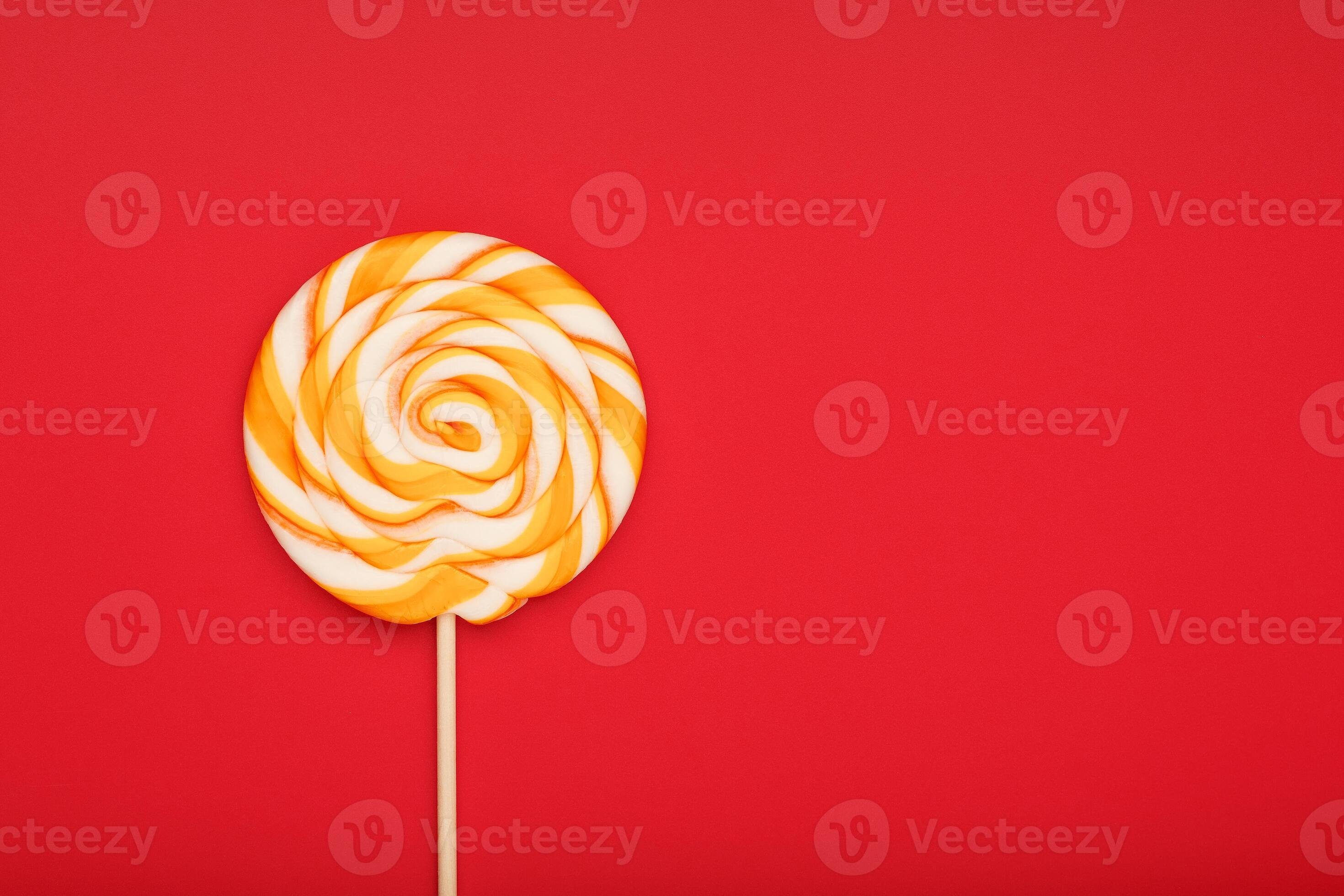A large yellow Lollipop, on a scarlet background. Minimal concept with