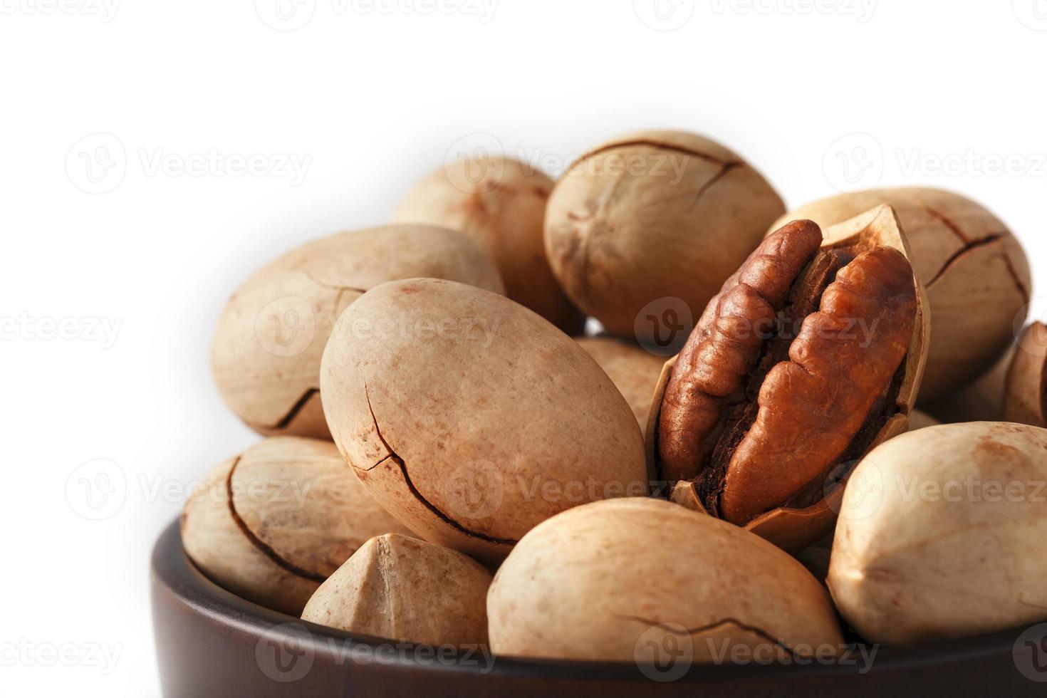Pecan in a wooden Cup isolated on a white background. Isolate. photo