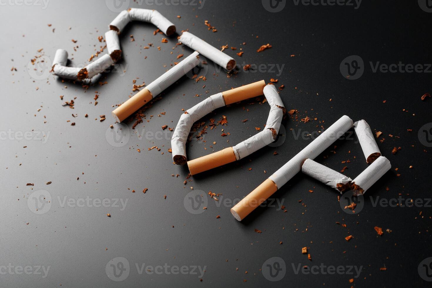 The inscription STOP from cigarettes on a black background. Stop smoking. The concept of smoking kills. Motivation inscription to quit smoking, unhealthy habit. photo