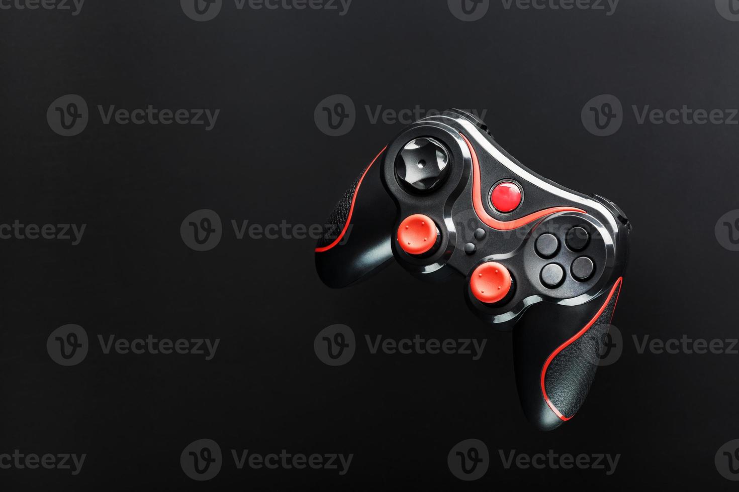 Game controller gamepad on black background. Device to control and control the game. photo