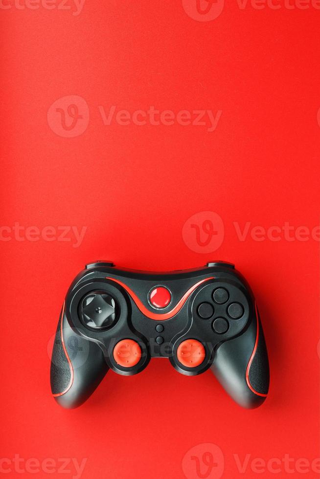 Game controller controller on red background. Device to control and control the game. photo