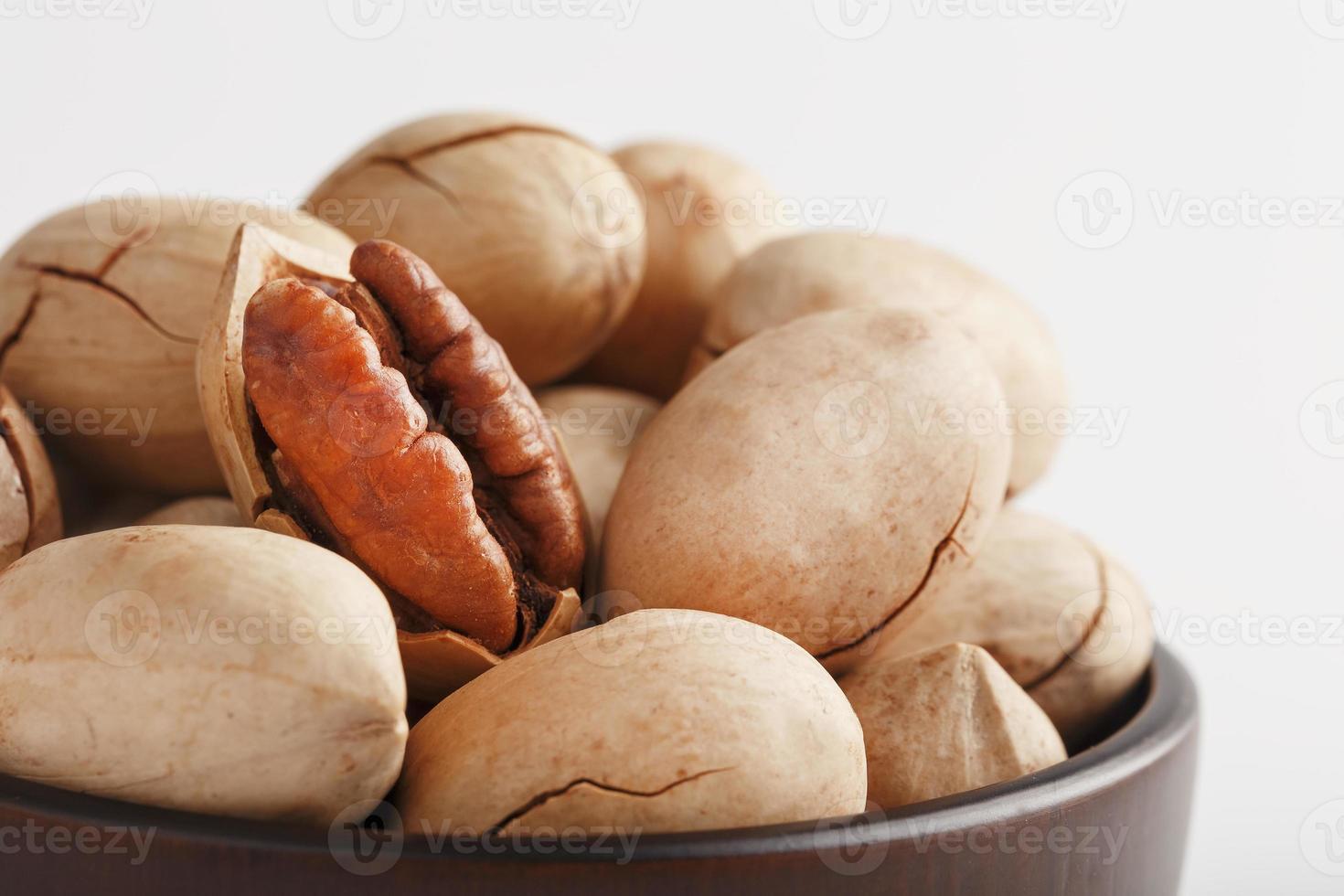 Pecan in a wooden Cup isolated on a white background. Isolate. photo