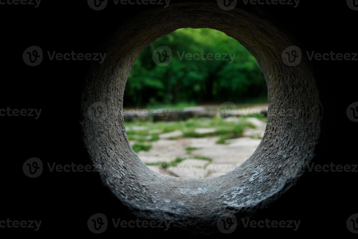 Inside view of a stone dolmen out through a hole in a mountain forest in the valley of the river Jean photo