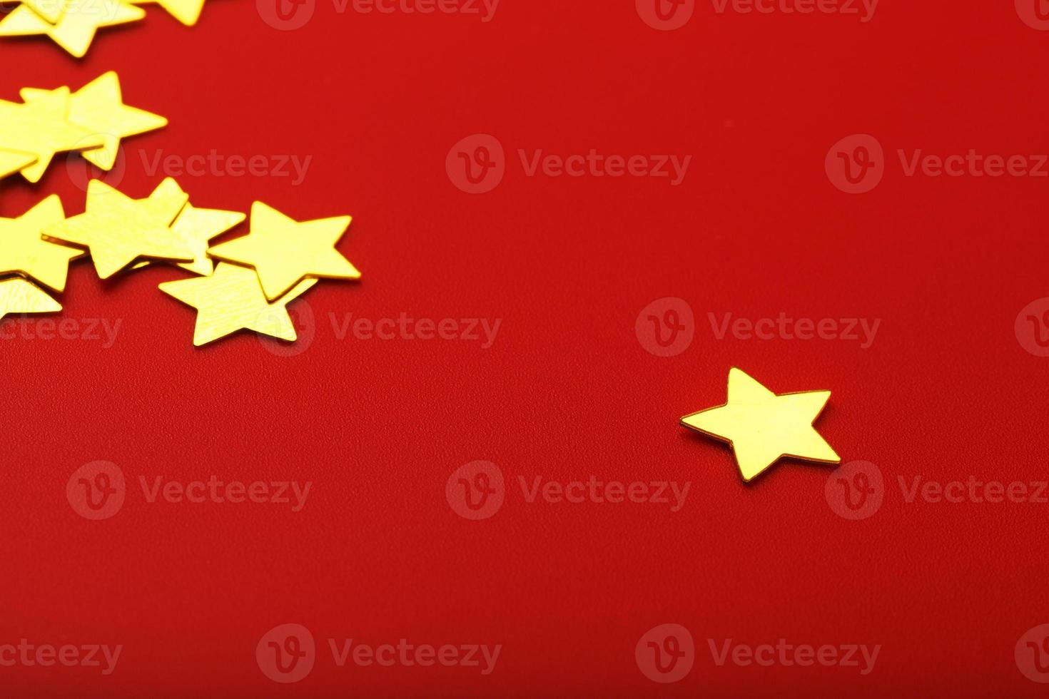 A scattering of Gold stars on a red background. Greeting cards, headlines and website concept. photo