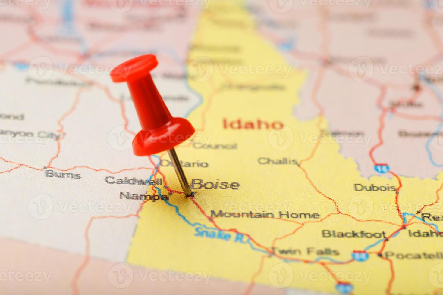 Red clerical needle on a map of USA, Idaho and the capital Boise. Closeup Map Idaho with Red Tack photo