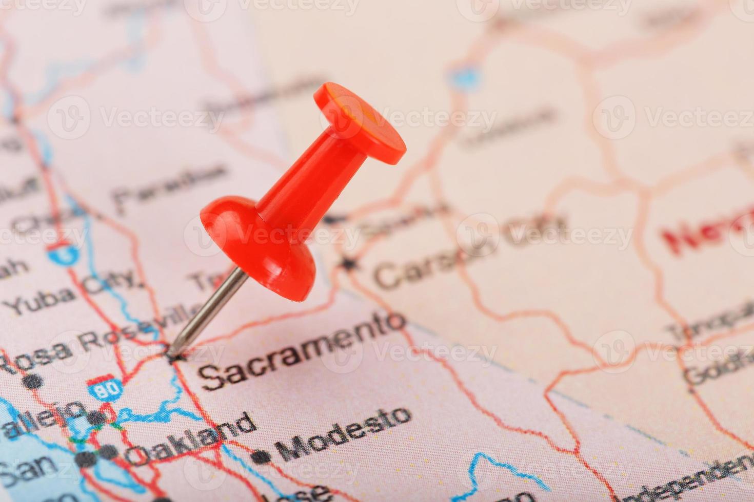 Red clerical needle on a map of USA, California and Sacramento Capital. Close up map of California with red tack photo