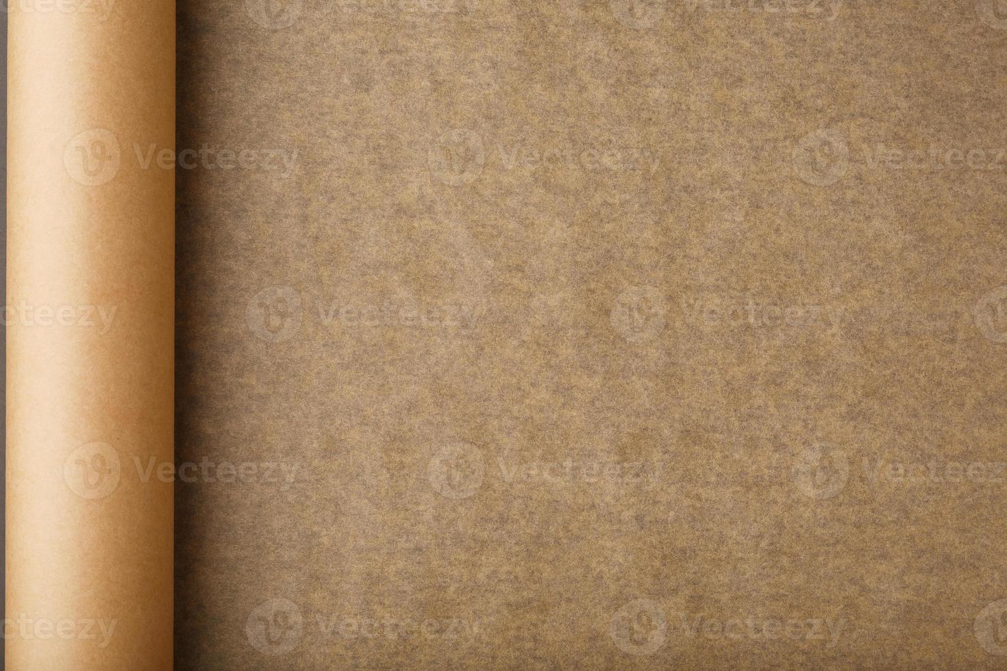 A roll of unfolded brown parchment paper, for baking food in on a dark  background, top view. 14595000 Stock Photo at Vecteezy