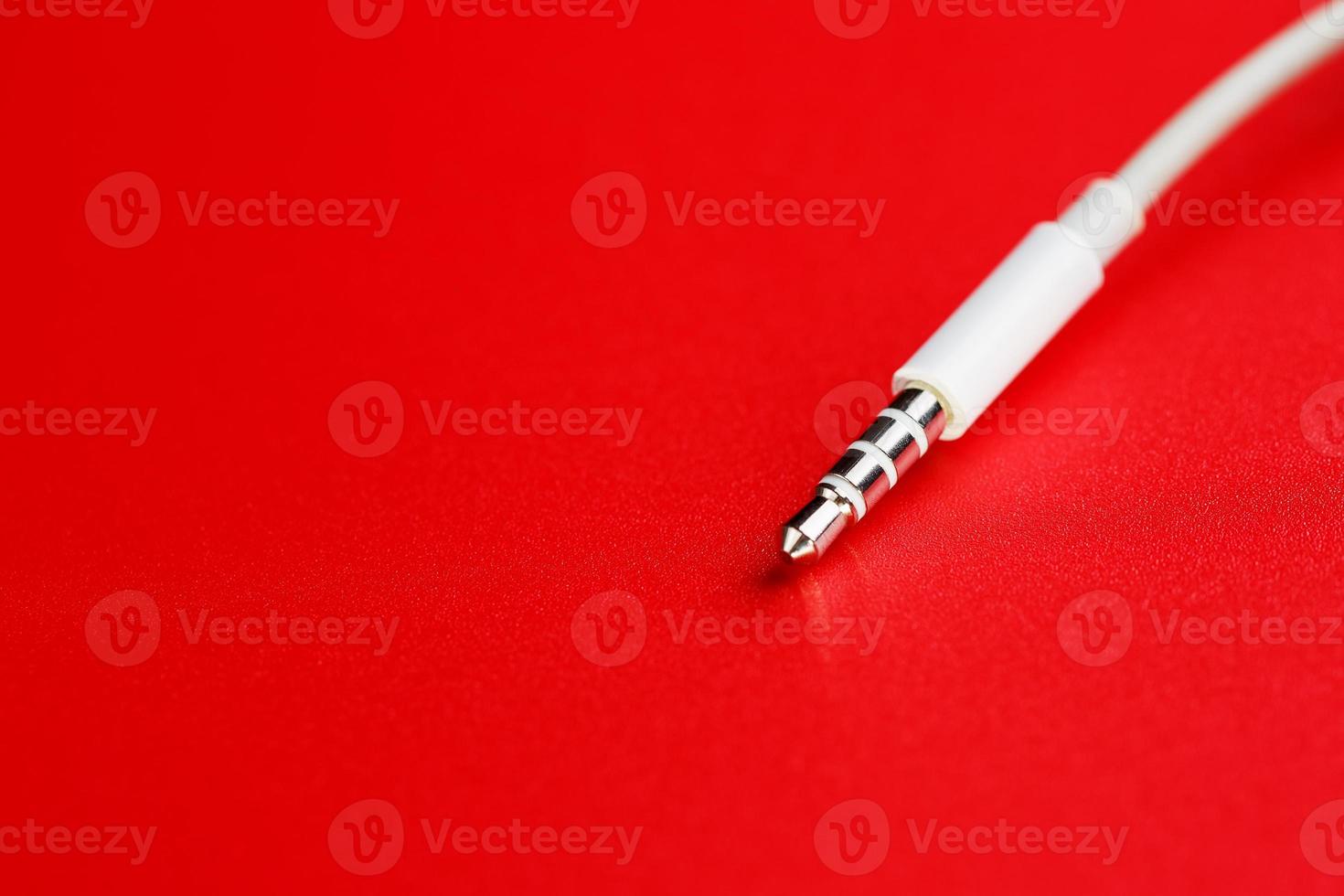 White connector AUX white cable on a red background photo