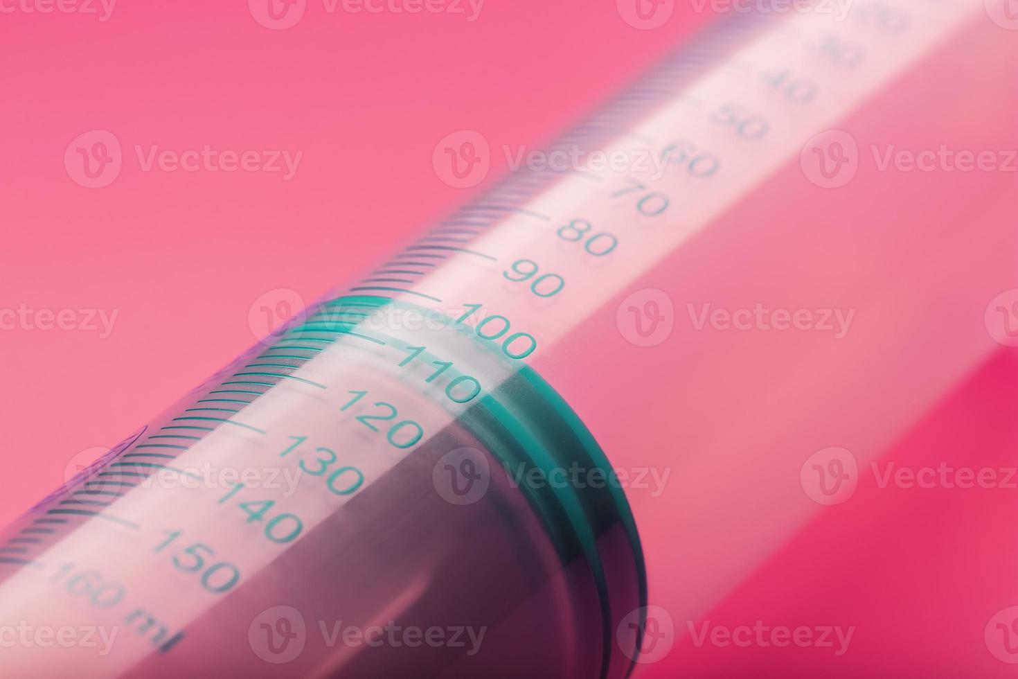 Syringe on pink background close-up, copy space. T photo