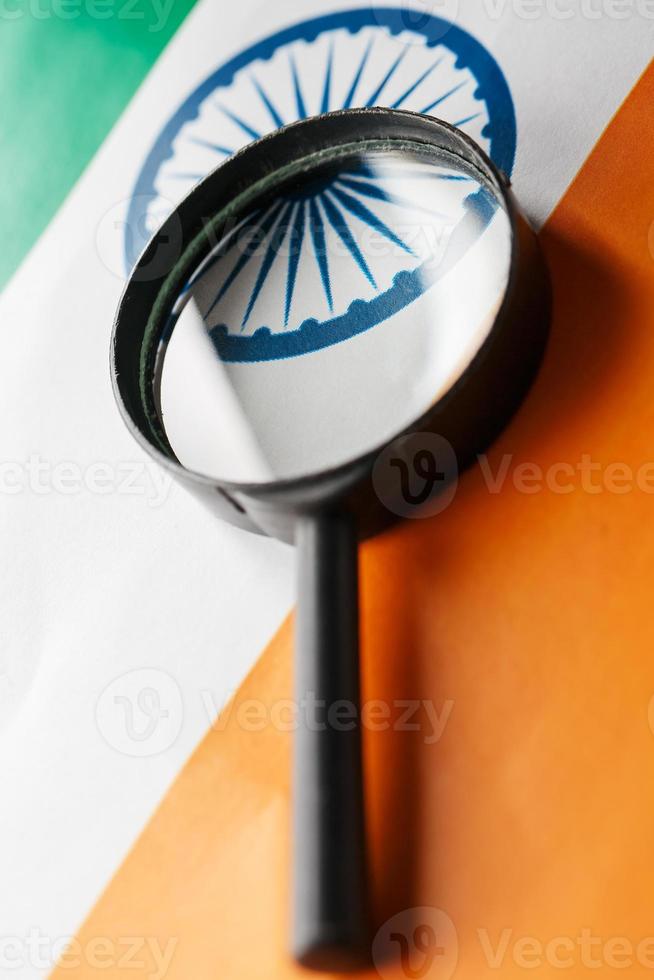 Learning Indian language concept. Young woman standing with the India flag in the background. Teacher holding books, orange blank book cover photo