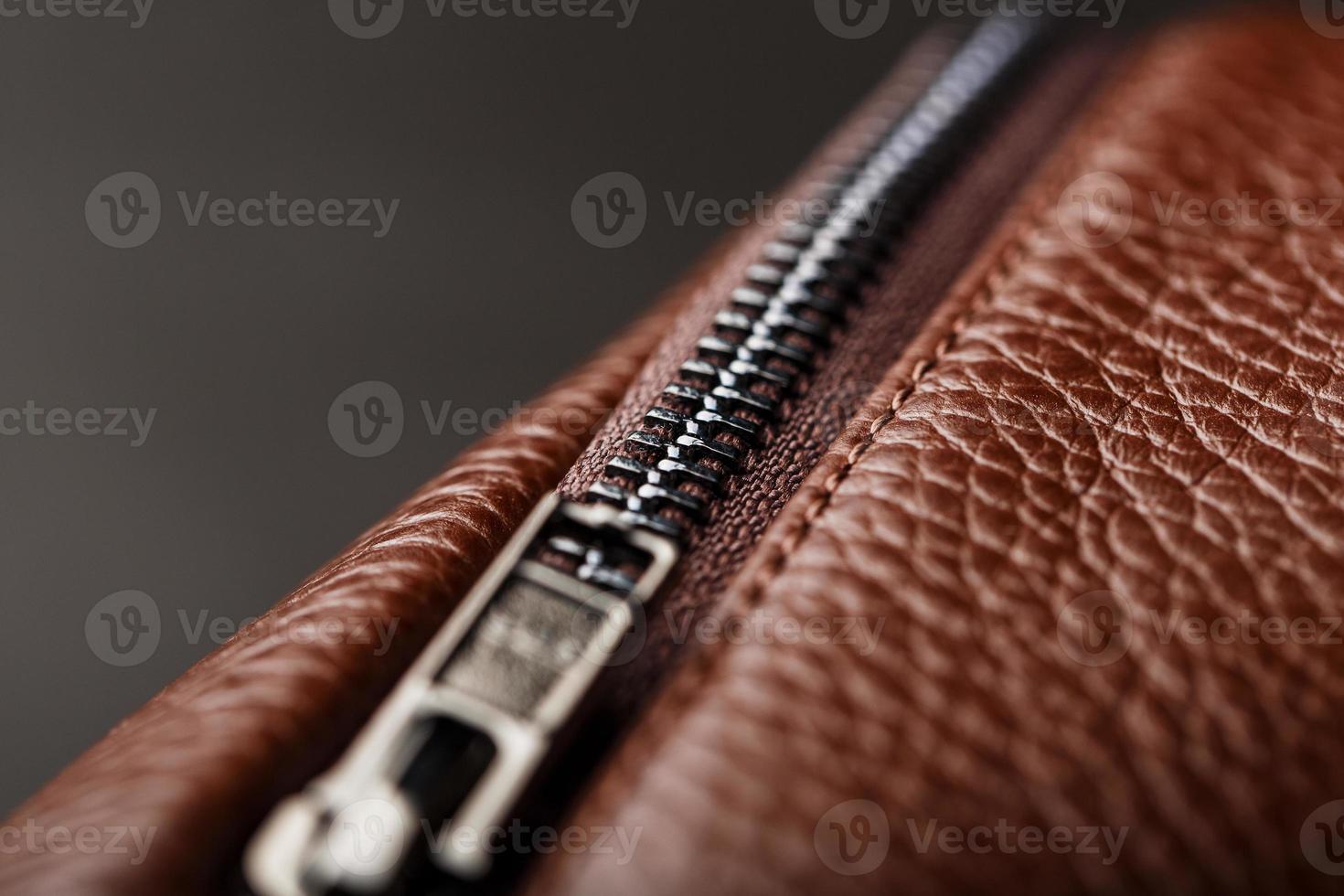 Brown backpack made of textured brown leather on a black stone background. Elegant golden brown women backpack with fashion and rivets photo