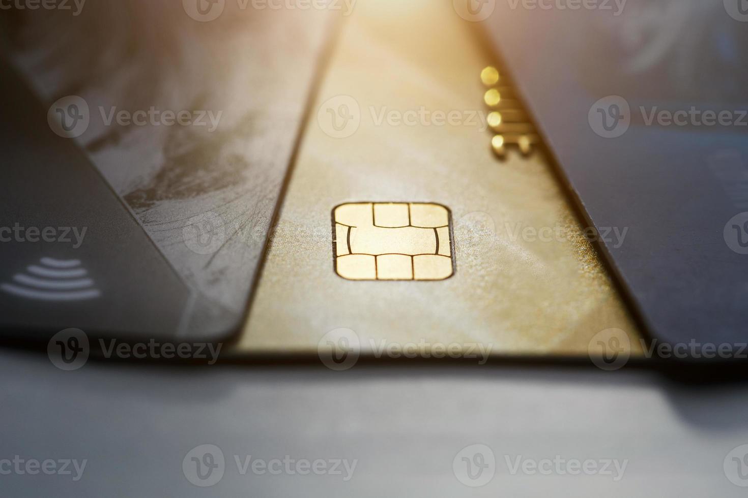 Selective focus microchip on paying by credit card or credit gold card for background. Contactless payments. photo