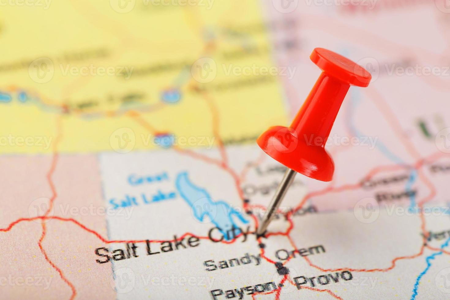 Red clerical needle on a map of USA, Utah and the capital Salt Lake City. Closeup Map Utah with Red Tack photo