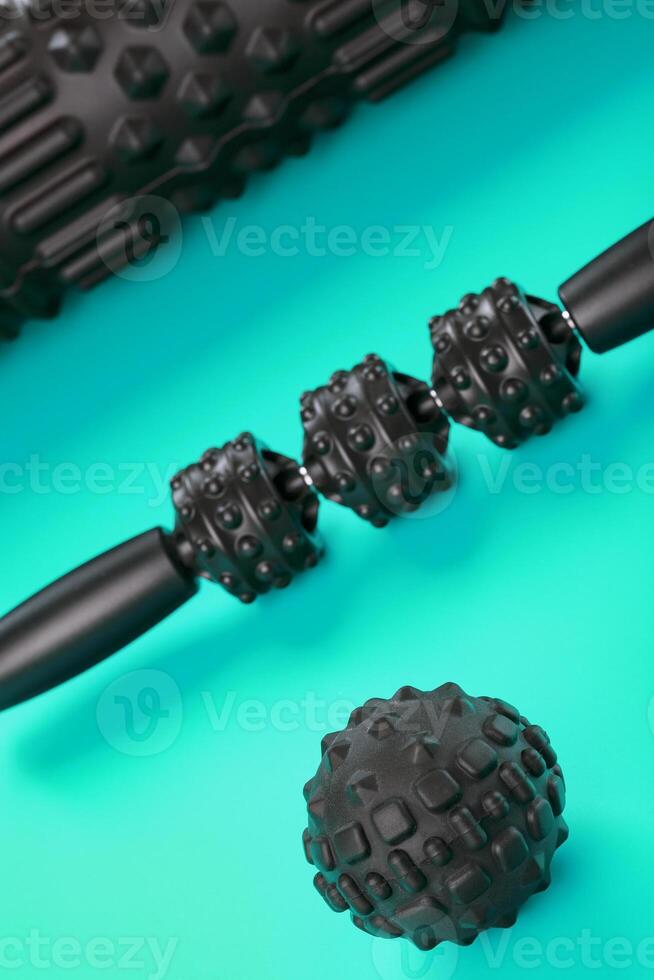 A set of black bumpy foam massage rollers, body rollers, rubber balls