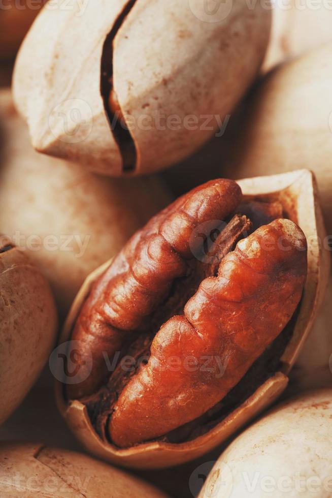 Pecan nuts close-up, macro as the background on the whole screen. photo