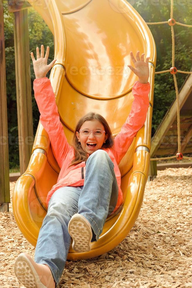 Teenage Girl is Having Fun in the Playground photo