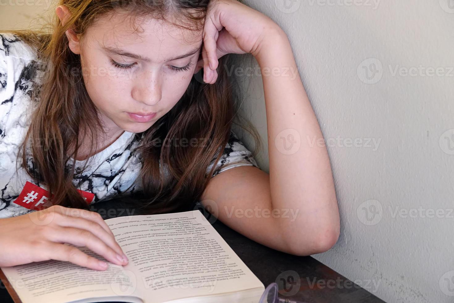 Young School Girl Studying her Lesson photo