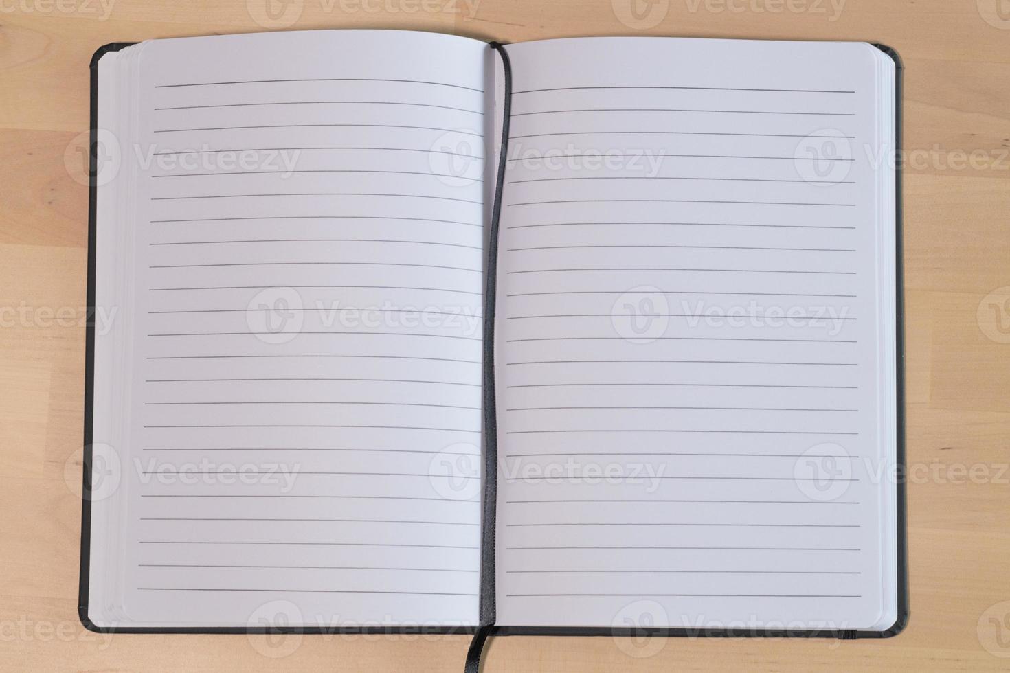 Empty lined notebook on wooden table. Ruled paper notebook photo