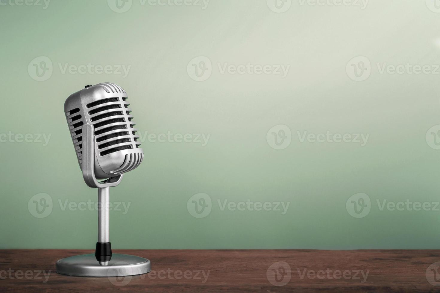 Retro microphone on wooden table vintage stlye photo